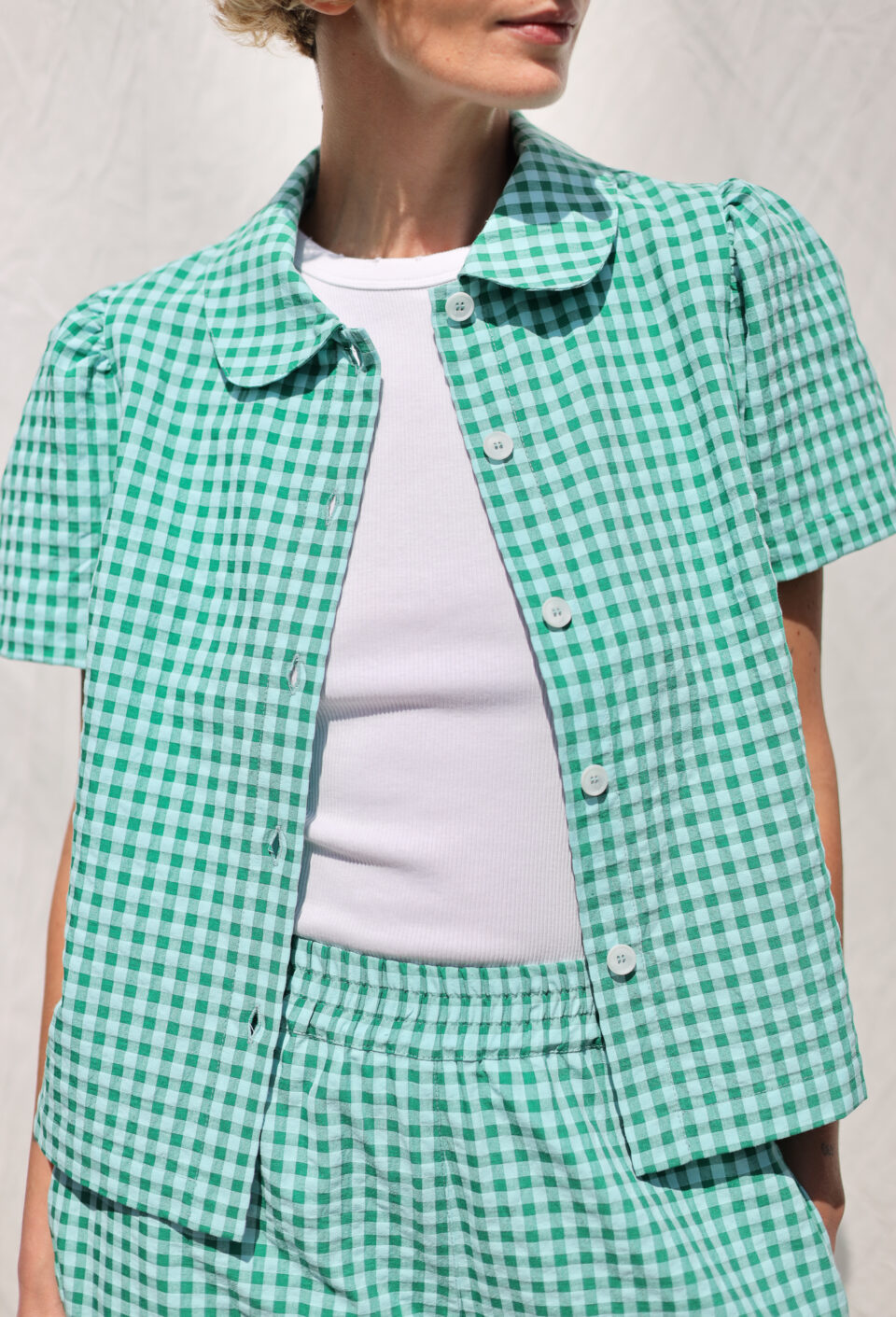 Peter Pan collar short sleeve blouse in jungle green seersucker checks