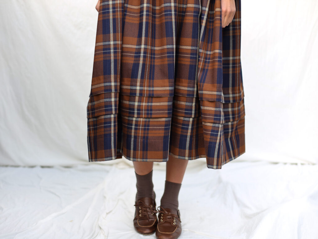 Oversized Plaid Wool Dress with Pleated Details - Image 1